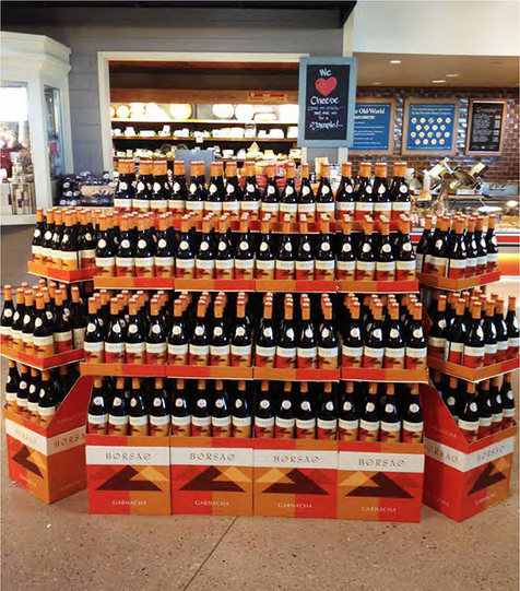 Example of a large wine case stack, the display was constructed by the supermarket, attracting customers by the strong branded graphic it naturally creates.